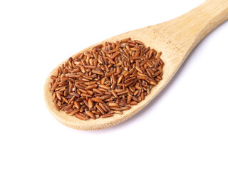 Raw red rice in a spoon isolated over white background