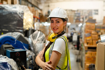 Portrait of female automation engineer smiling hold helmet in modern industrial factory.