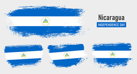 Textured collection national flag of Nicaragua on painted brush stroke effect with white background