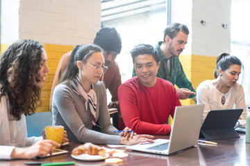 Young co-workers multiethnic team planning a new startup - Happy people working on a new project in...
