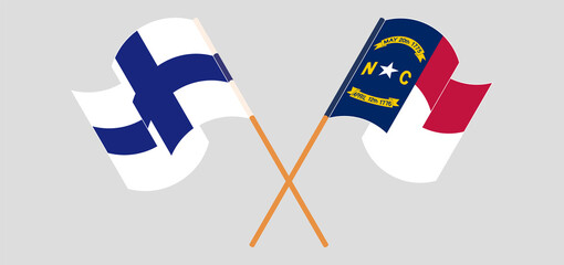 Crossed and waving flags of Finland and The State of North Carolina