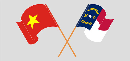 Crossed and waving flags of Vietnam and The State of North Carolina