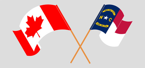 Crossed and waving flags of Canada and The State of North Carolina