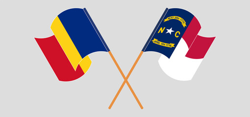 Crossed and waving flags of Romania and The State of North Carolina