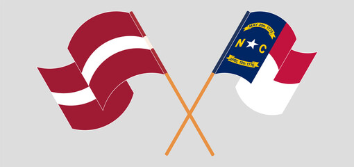 Crossed and waving flags of Latvia and The State of North Carolina