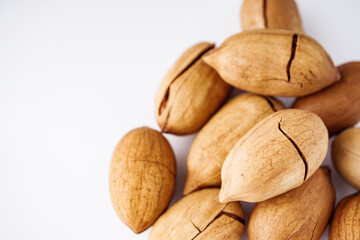 delicious fresh pecans on a white acrylic background