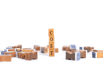 Stamp Wooden cubes form the word cost spelled letters. Concept of production cost management, cost...
