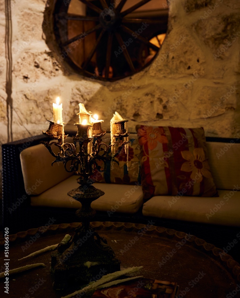 Wall mural Vertical shot of candles on a candelabra inside a home in Tulum, Quintana Roo, Mexico