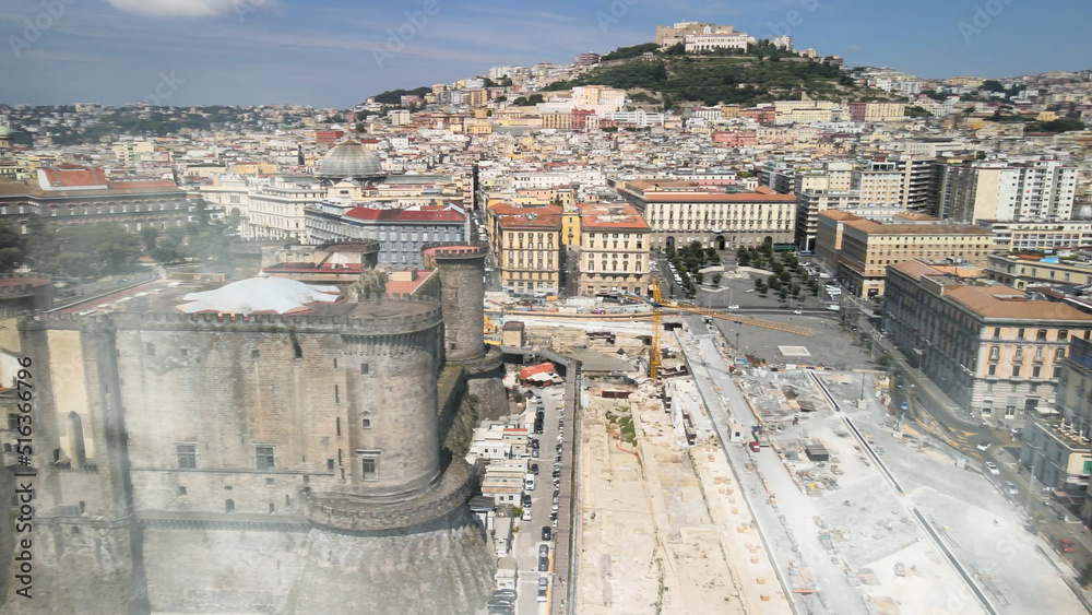 Wall mural naples, italy. aerial view of city port from a drone going up in the sky.