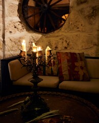 Vertical shot of candles on a candelabra inside a home in Tulum, Quintana Roo, Mexico - obrazy, fototapety, plakaty