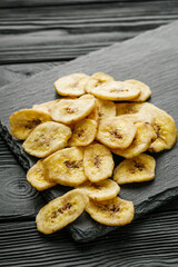 delicious dried banana on a black wooden rustic background