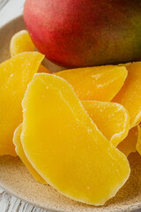 delicious dried mango on a white wooden rustic background