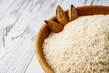 almond flour on a white wooden rustic background