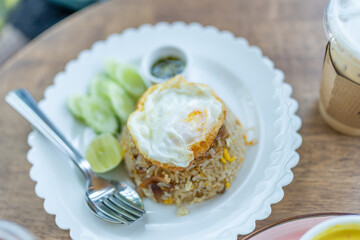 Tasty appetizing classic italian spaghetti pasta with creamy sauce, cheese parmesan and basil on plate on dark table at cafe restuarant. 