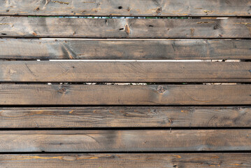 Fototapeta na wymiar Textured background of old wooden boards laid out in a row.