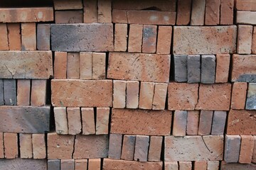 Red bricks pile stacked for construction