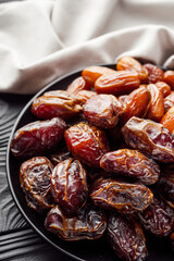 juicy royal dates on a black wooden rustic background