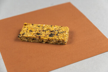 Protein Energy Bar on brown. A gluten-free, sugar-free snack. Oatmeal flapjack with fruit. Healthy Foods.