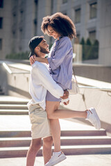 Young couple hugging outside and looking excited