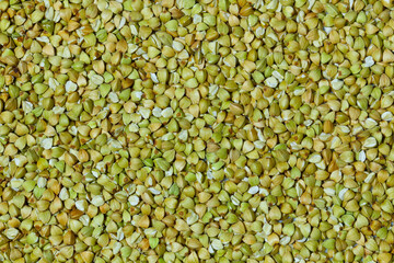 Natural Green Raw Buckwheat Groats. Raw not steamed buckwheat grains. Organic buckwheat grains ready for cooking porridge. Ecologically clean healthy food. Gluten Free. GMO Free. Top view. Close-up