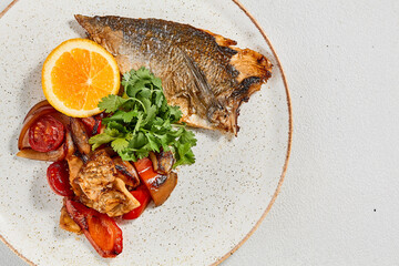 Fish dish - roasted dorado fillet with vegetables. Grilled fish fillet and roasted paprika,...