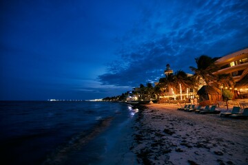 Night illumination of coast, night bars, cafes on beach of Playa del Carmen Quintana Roo Mexico.