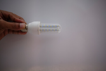 hand holding a light bulb