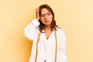 Young nutritionist hispanic woman isolated on yellow background being shocked, she has remembered important meeting.