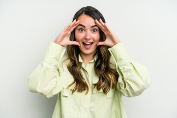 Young caucasian woman isolated on white background receiving a pleasant surprise, excited and raising hands.
