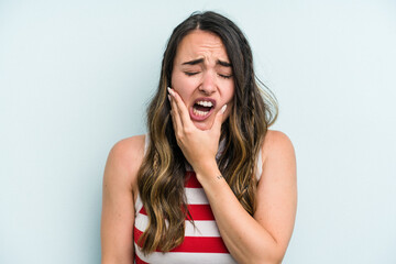 Young caucasian woman isolated on blue background having a strong teeth pain, molar ache.