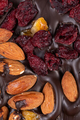 bar of natural Dark dark chocolate with citrus, pieces roasted almonds and cranberries