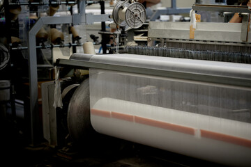 Fototapeta na wymiar Industrial textile production line. Weaving looms in a textile factory