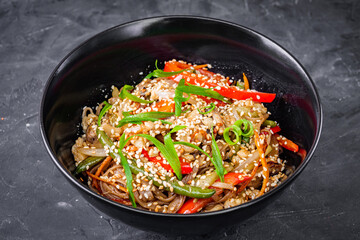 delicious chinese fried noodles on a black background