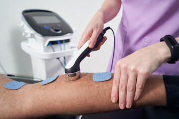 Man having ultrasound therapy procedure in physical therapy clinic - obrazy, fototapety, plakaty