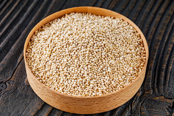 white quinoa seeds on a dark rustic background