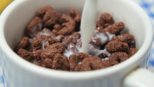 chocolate corn flakes in a bowl on table