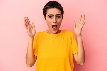 Fototapeta premium Young caucasian woman isolated on blue background celebrating a victory or success, he is surprised and shocked.