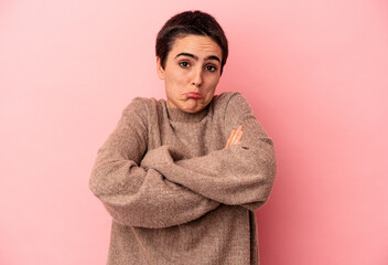 Young caucasian woman isolated on blue background shrugs shoulders and open eyes confused.