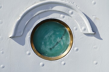 scratched porthole of the old battleship