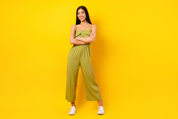 Full size photo of stunning positive thai lady crossed hands toothy smile posing isolated on yellow color background