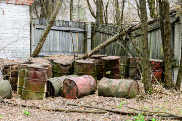 Rusty fuel barrels near the abandoned warehouse at Chernobyl exclusion zone