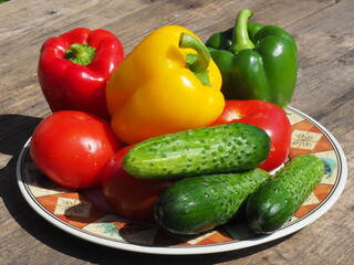 Tomatoes, cucumbers and paprika on the table. Healthy organic food. Harvest from garden