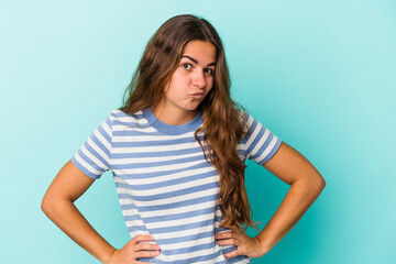 Young caucasian woman isolated on blue background  confused, feels doubtful and unsure.