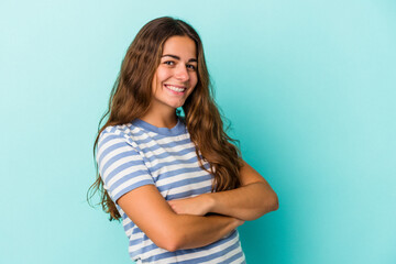 Obraz premium Young caucasian woman isolated on blue background happy, smiling and cheerful.