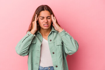 Young caucasian woman isolated on pink background  touching temples and having headache.