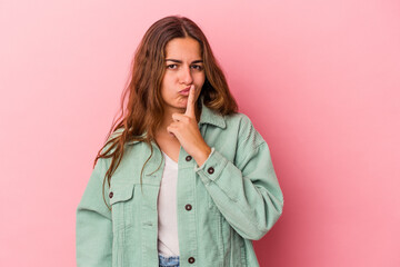 Young caucasian woman isolated on pink background  thinking and looking up, being reflective, contemplating, having a fantasy.