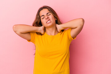 Young caucasian woman isolated on pink background  suffering neck pain due to sedentary lifestyle.