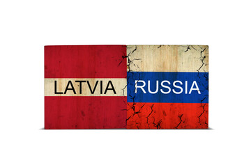 Flags of Latvia and Russia on wooden blocks. Isolated on white background. Conflict between Poland and Russia.Politics.