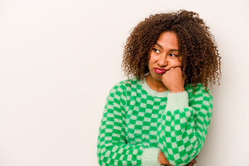 Young African American woman isolated on white background who feels sad and pensive, looking at copy space.