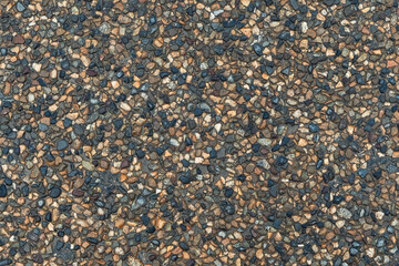 Texture of small multi-colored stones. Asphalt background.